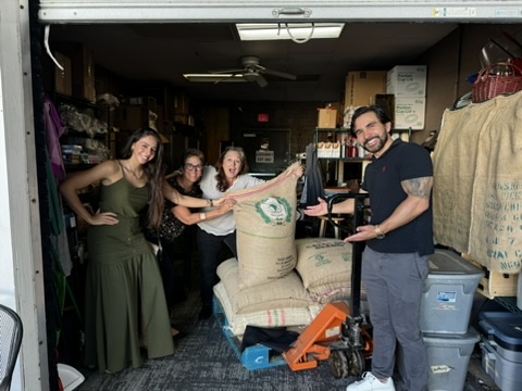 Julia and Diego of Mara Madeira Coffee hand-delivering sacks of Brazilian beans to Friendship Coffee Company